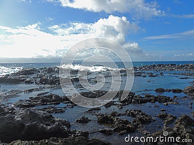 Coastline and rugged lava rocks called Dragonâ€™s Teeth and crashing waves at Makaluapuna Point near Kapalua, Maui, HI, USA Stock Photo